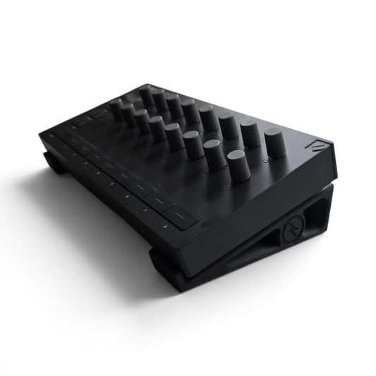 Black stand holding a Launch Control device, top view of buttons and dials