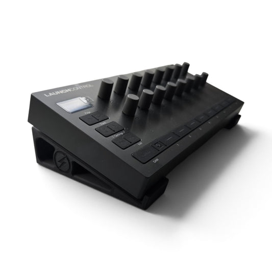 Black stand holding a Launch Control device, knobbed top and labeled controls