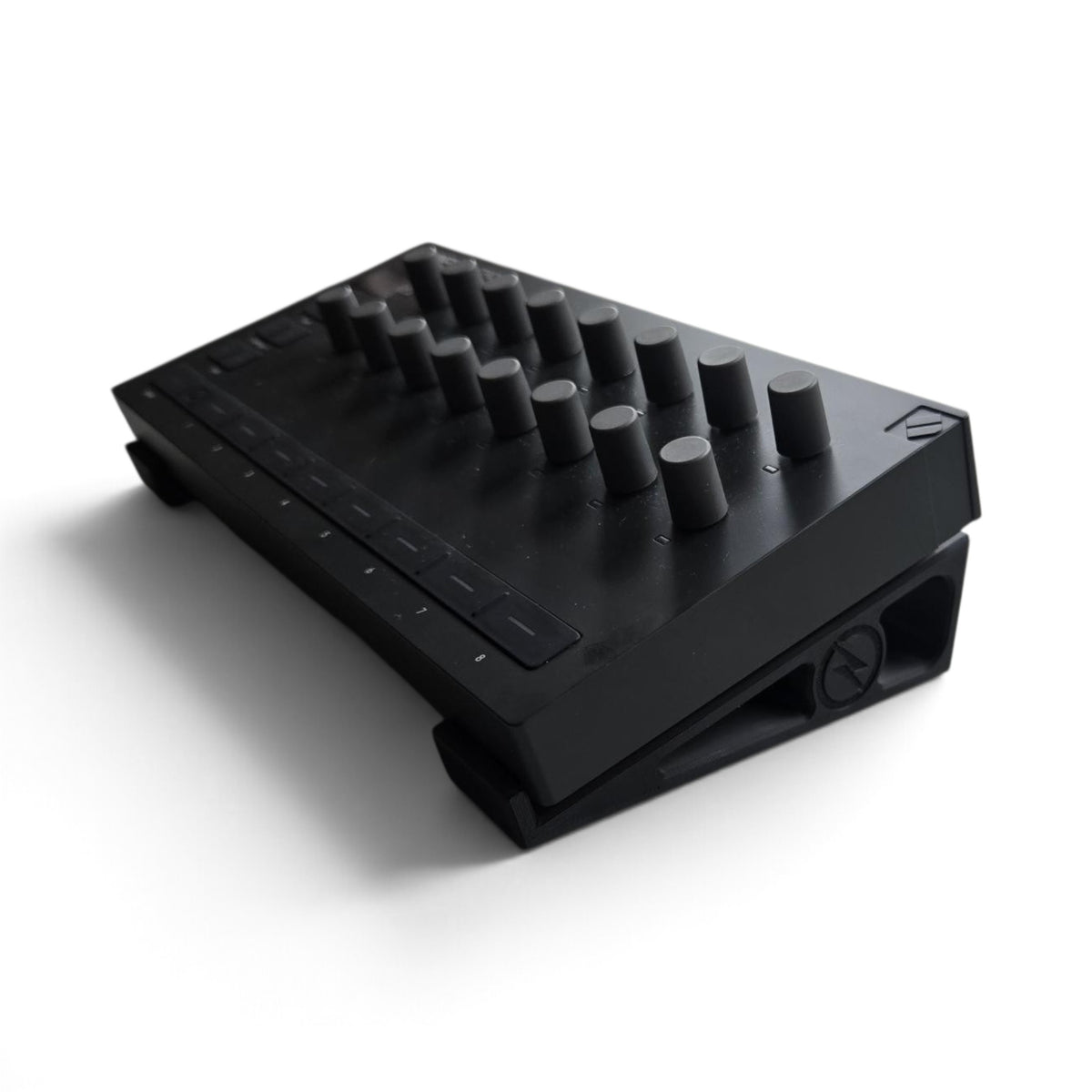 Black stand holding a Launch Control device, top view of buttons and dials