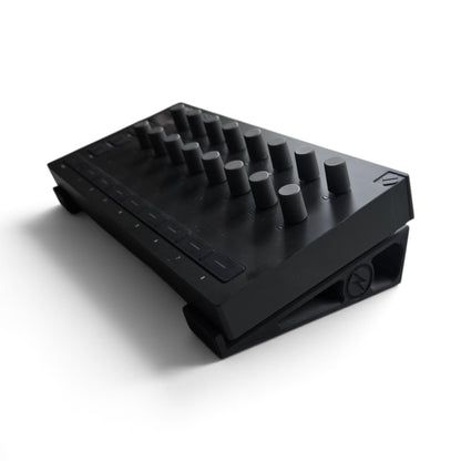 Black stand holding a Launch Control device, top view of buttons and dials