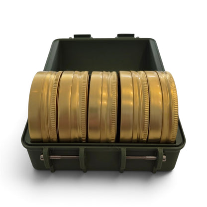 Olive pellet storage case open with rows of gold-colored round tins inside